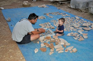 Justin gives Max his first lesson in sorting ceramics.