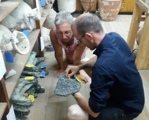 Hirschfeld and Lehner inspect an ingot fragment at INA's Research Center in Bodrum, Turkey.