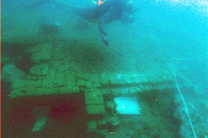 Diver hovering over the remains of a building (Photo: INA) Slide # PR-diver-a.