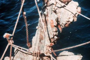 Raising a concretion of anchors. All of the anchors were completely covered in this type of concretion. (Photo: INA) Slide# YA7-409. REF751